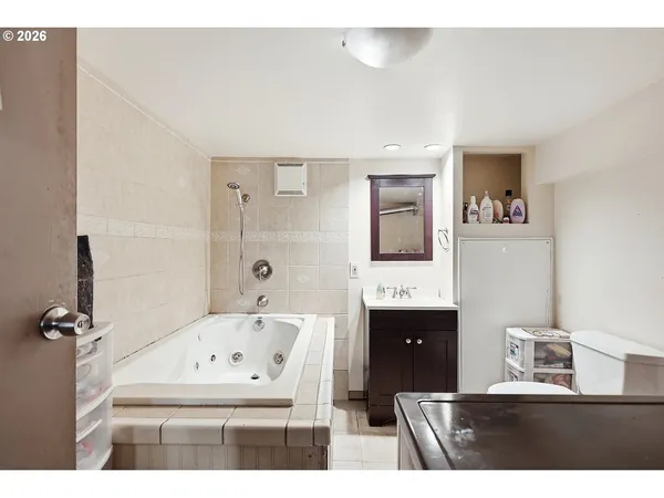 a bathroom with a bathtub sink and mirror