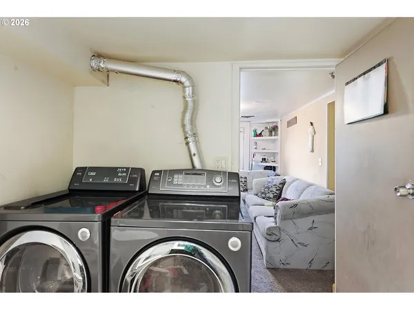 a utility room with closet dryer and washer