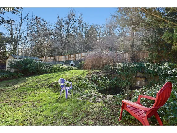 a backyard with table and chairs