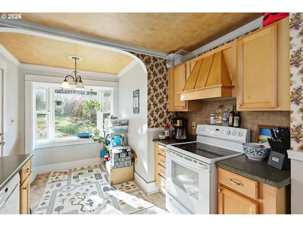 a kitchen with a stove a refrigerator and cabinets