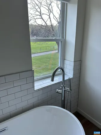 a bathroom with a bathtub and window