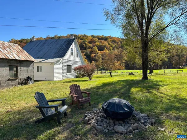 a backyard of a house with table and chairs