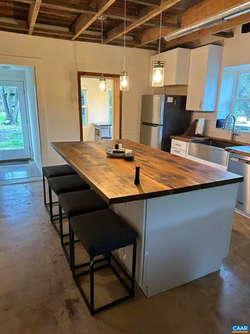 a room with table chairs and wooden floor