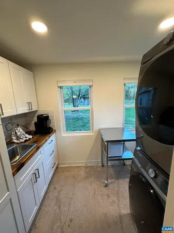 a kitchen with a sink and a stove top oven