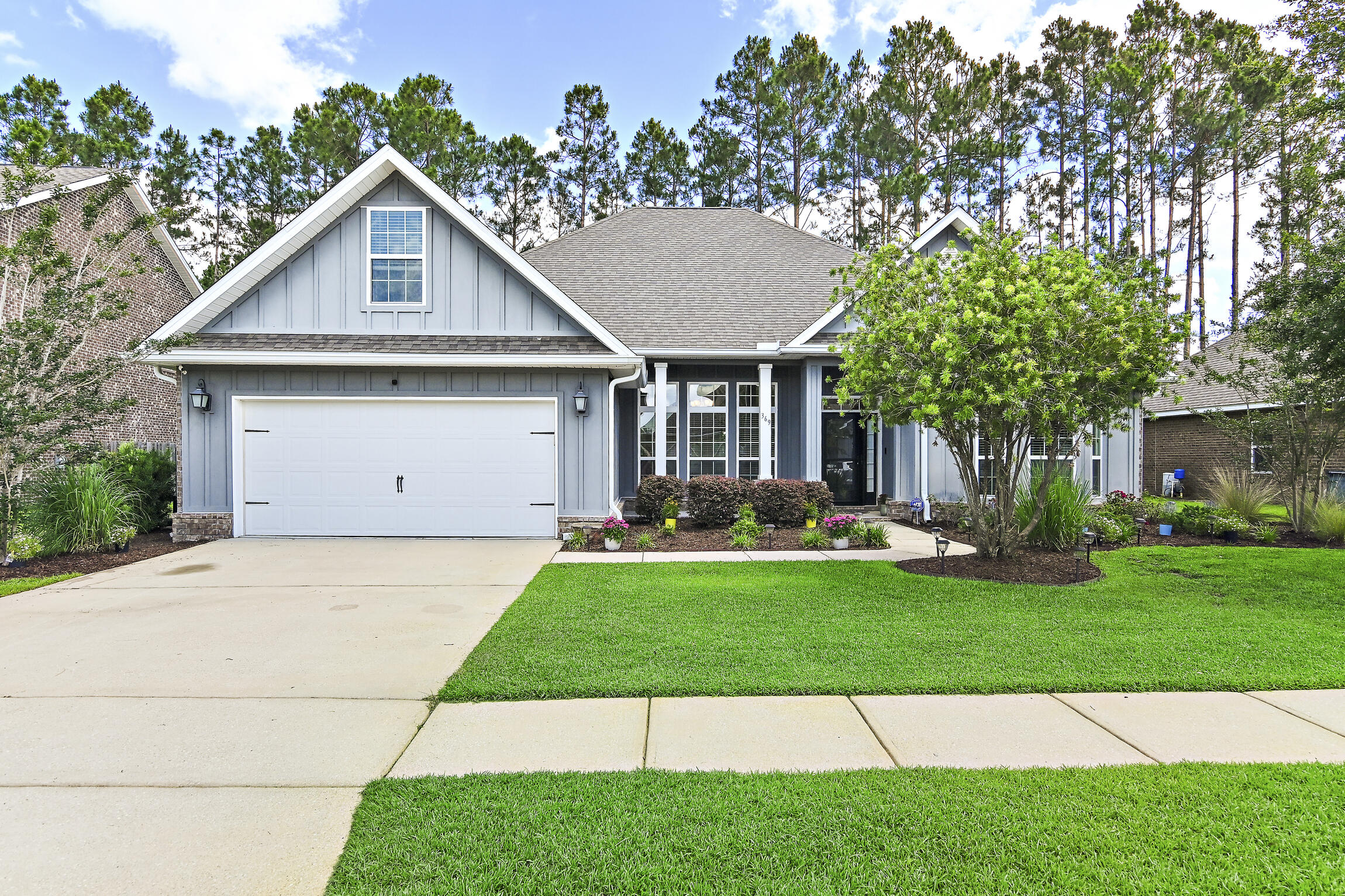 369 Lilly Bell Lane Freeport, FL 32439 - Photo 1 of 24 a aerial view of a house with a yard and garage