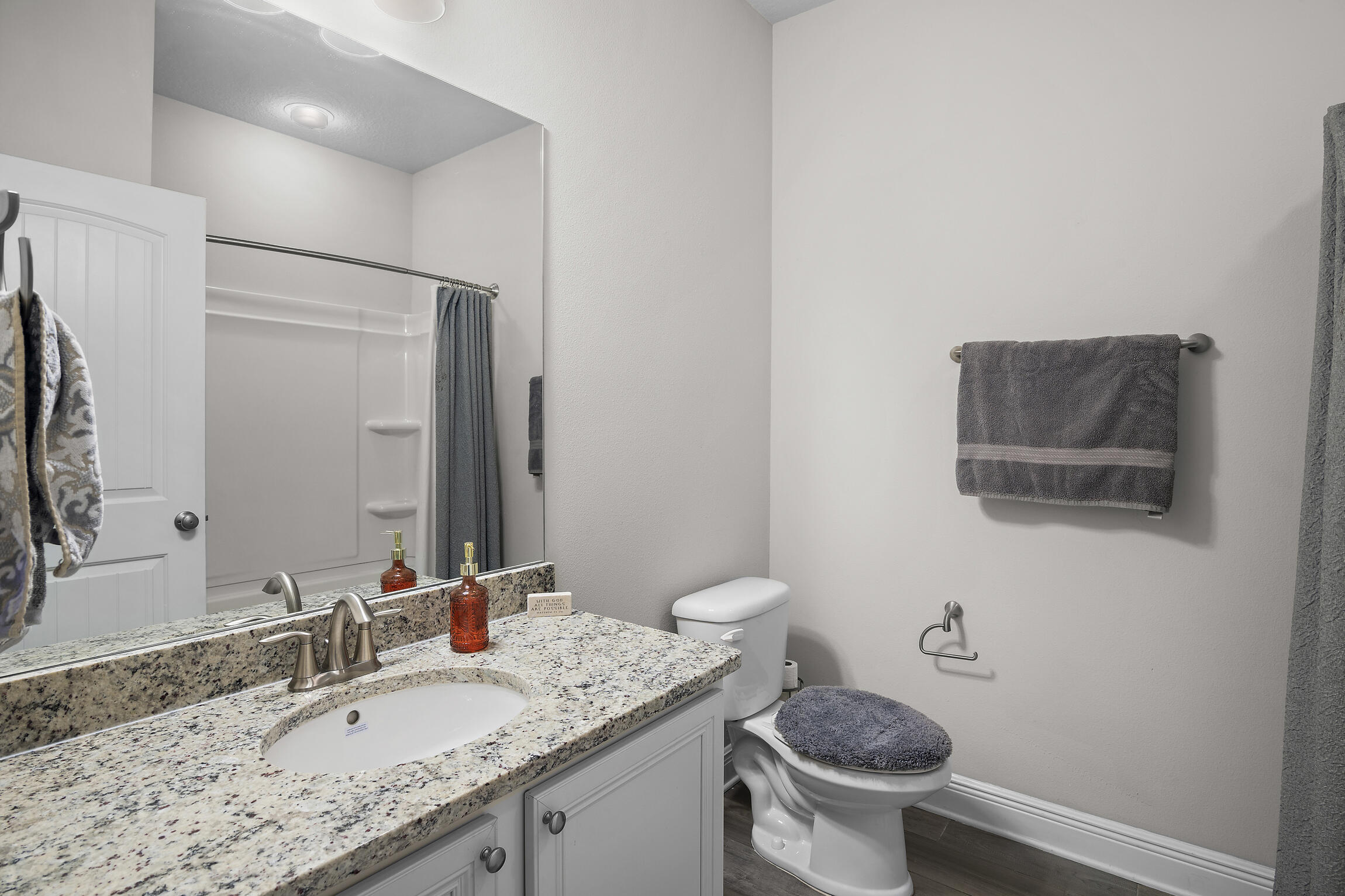 369 Lilly Bell Lane Freeport, FL 32439 - Photo 14 of 24 a bathroom with a granite countertop sink a toilet and a mirror