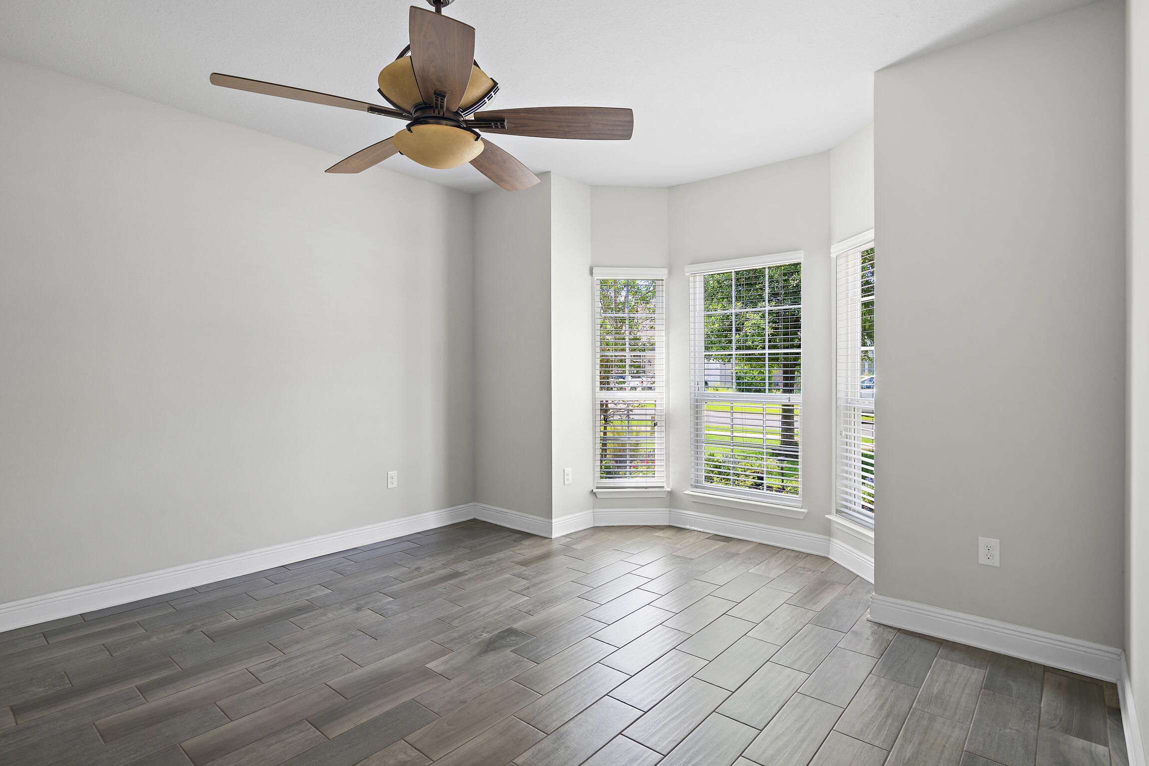 369 Lilly Bell Lane Freeport, FL 32439 - Photo 16 of 24 a view of an empty room with a window and wooden floor