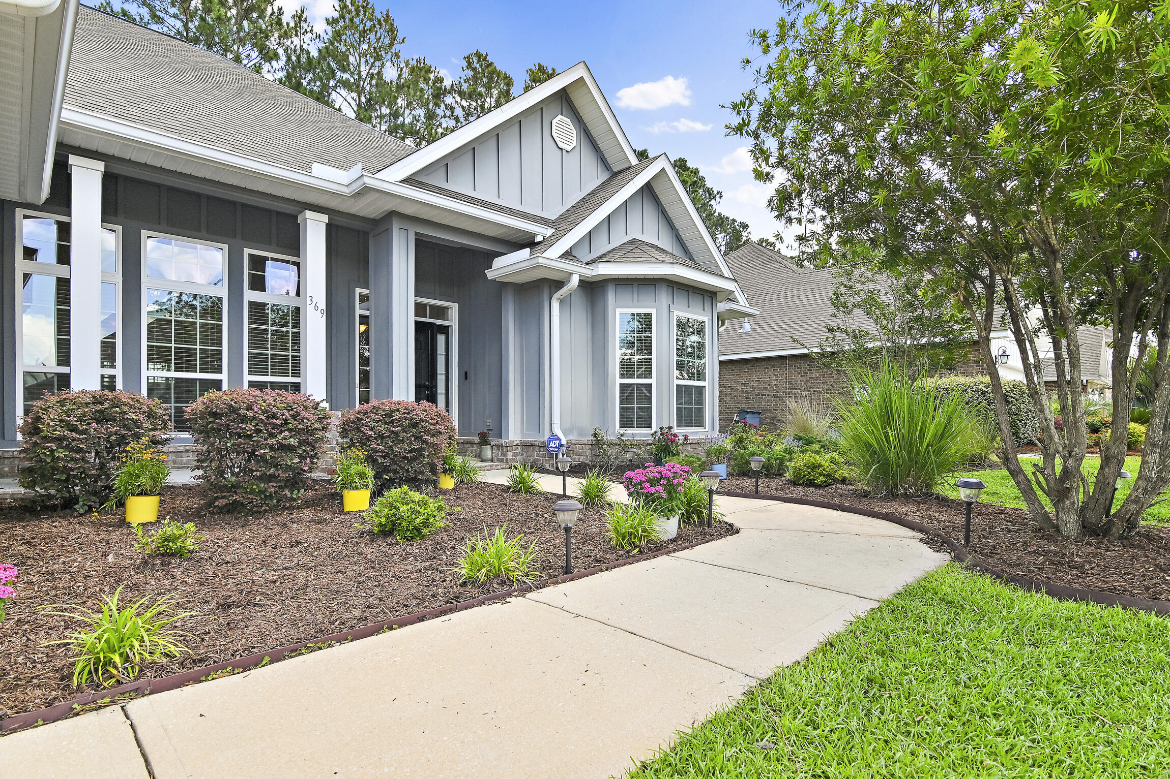 369 Lilly Bell Lane Freeport, FL 32439 - Photo 2 of 24 a front view of a house with garden