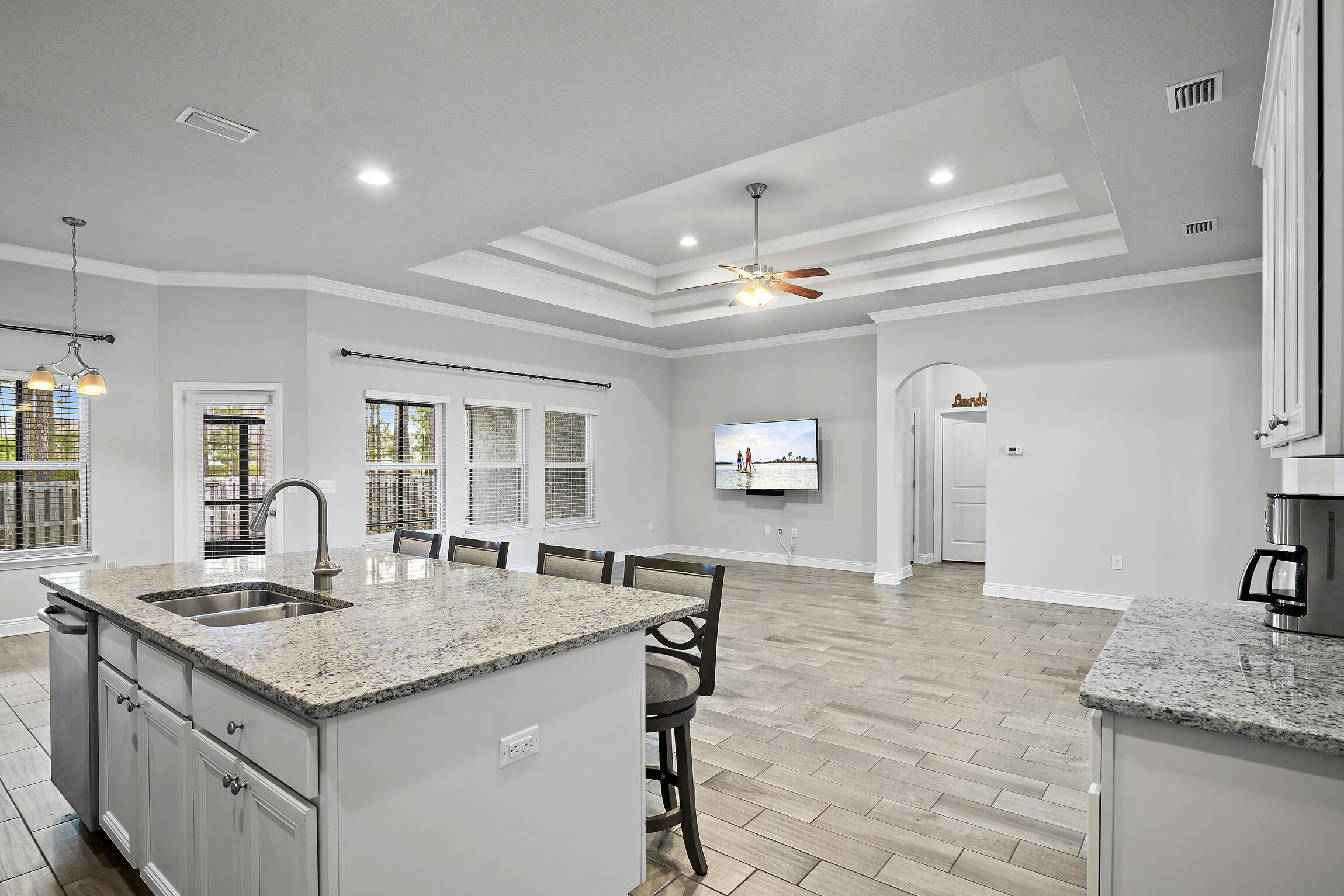 369 Lilly Bell Lane Freeport, FL 32439 - Photo 5 of 24 a kitchen with granite countertop cabinets a sink dishwasher and a stove with wooden floor