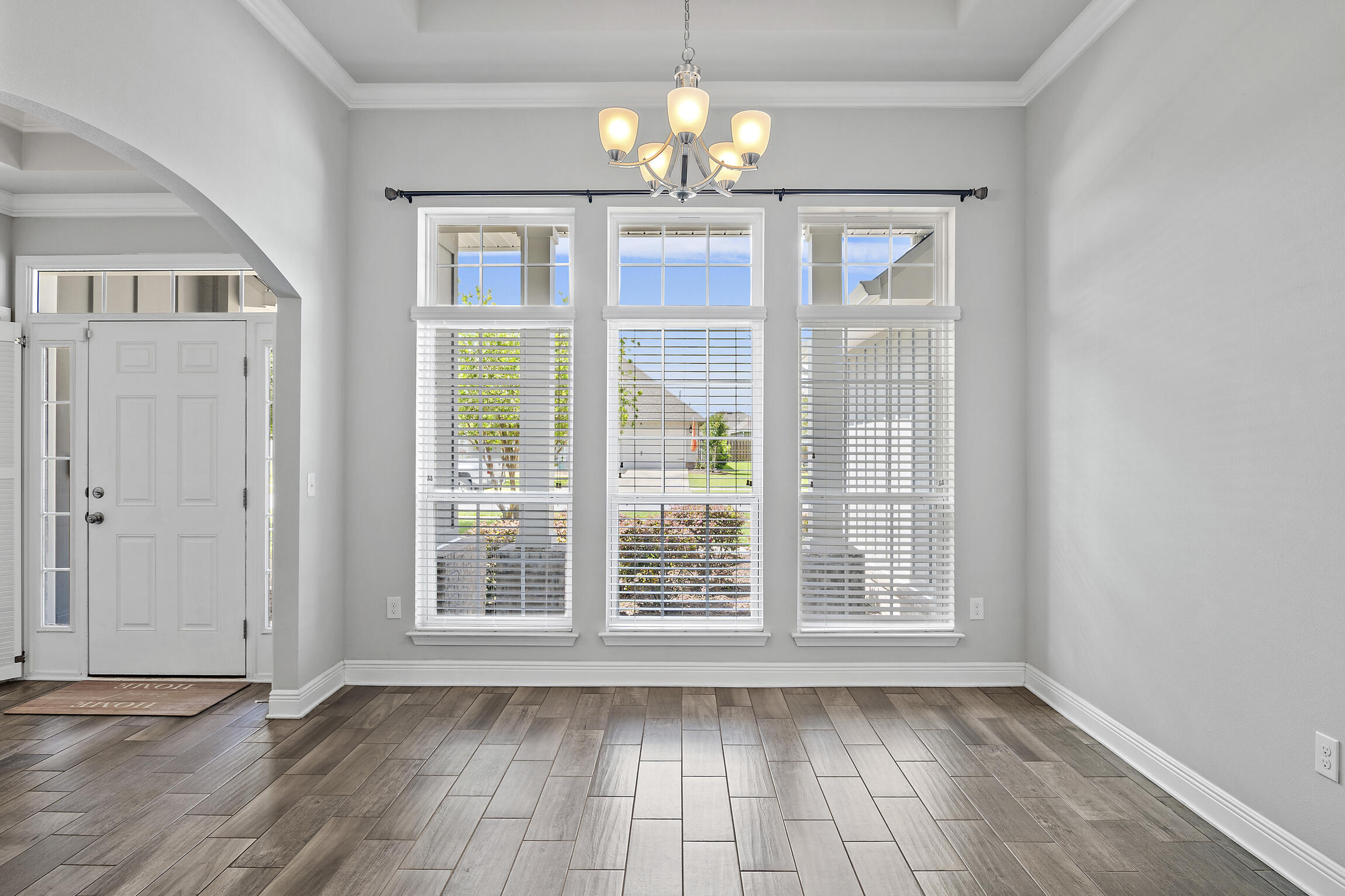 369 Lilly Bell Lane Freeport, FL 32439 - Photo 8 of 24 a view of an empty room with wooden floor and a window