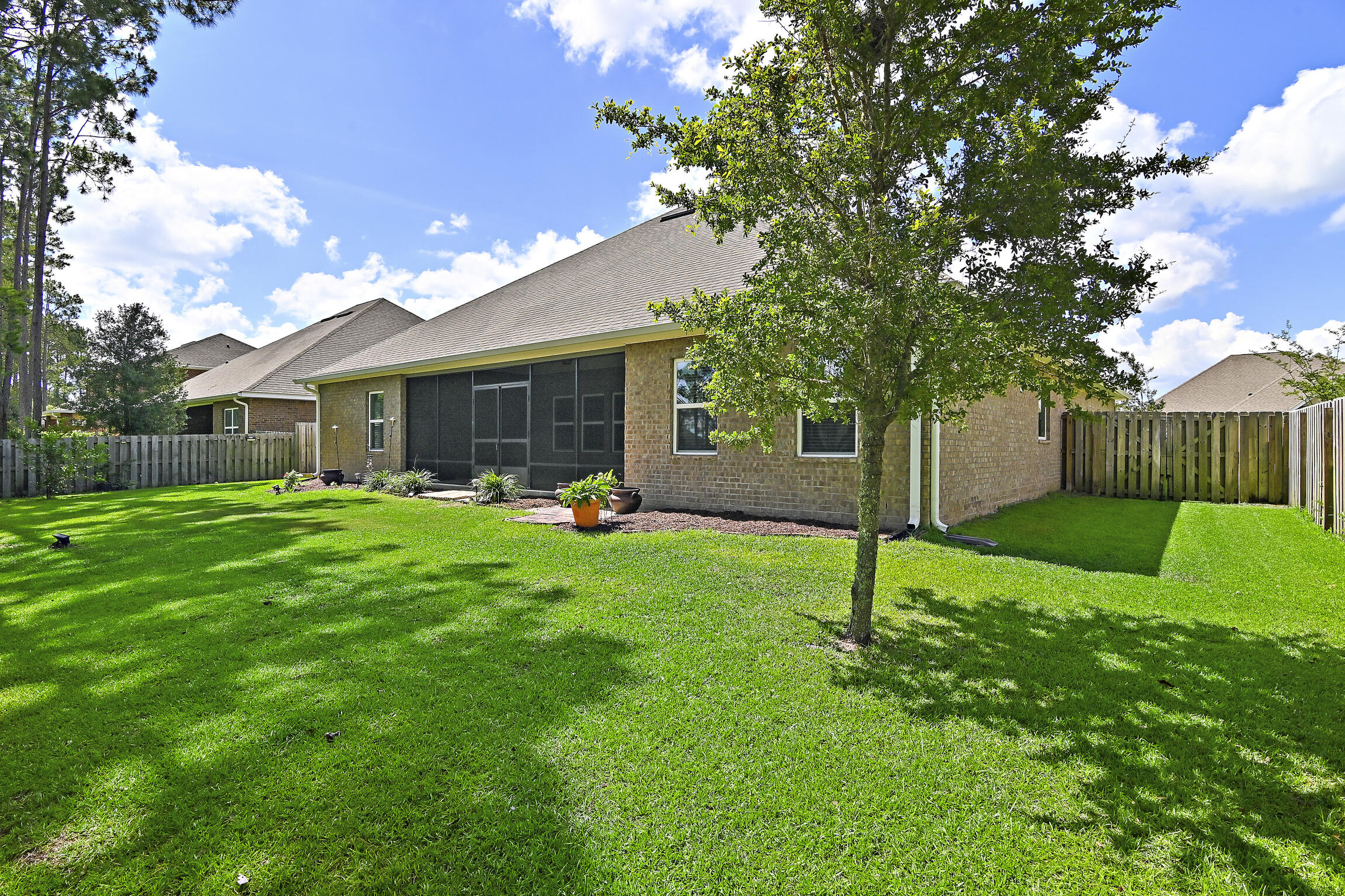 369 Lilly Bell Lane Freeport, FL 32439 - Photo 10 of 24 a view of a house with a yard and tree