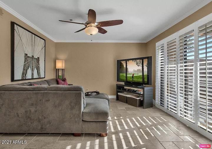 3500 North Hayden Road, Unit 1511 Scottsdale, AZ 85251 - Photo 1 of 26 a living room with furniture and a flat screen tv