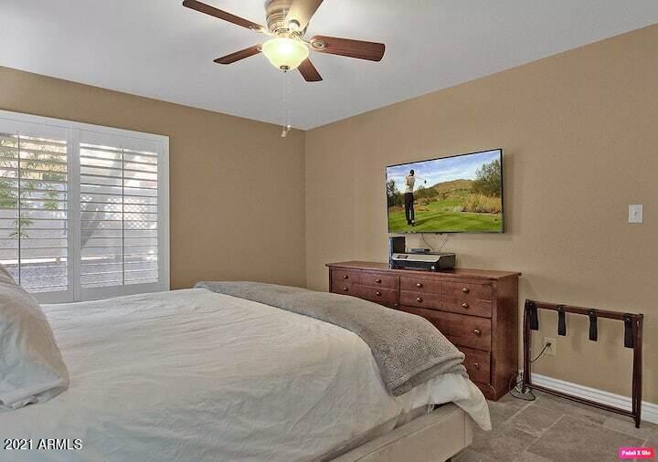 3500 North Hayden Road, Unit 1511 Scottsdale, AZ 85251 - Photo 12 of 26 a bedroom with a bed and a flat screen tv