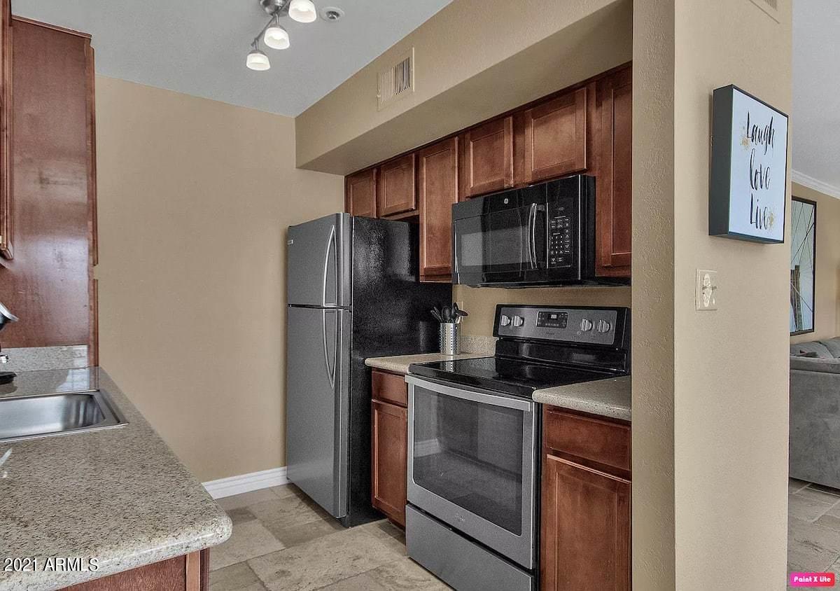 3500 North Hayden Road, Unit 1511 Scottsdale, AZ 85251 - Photo 6 of 26 a kitchen with stainless steel appliances granite countertop a refrigerator stove and sink