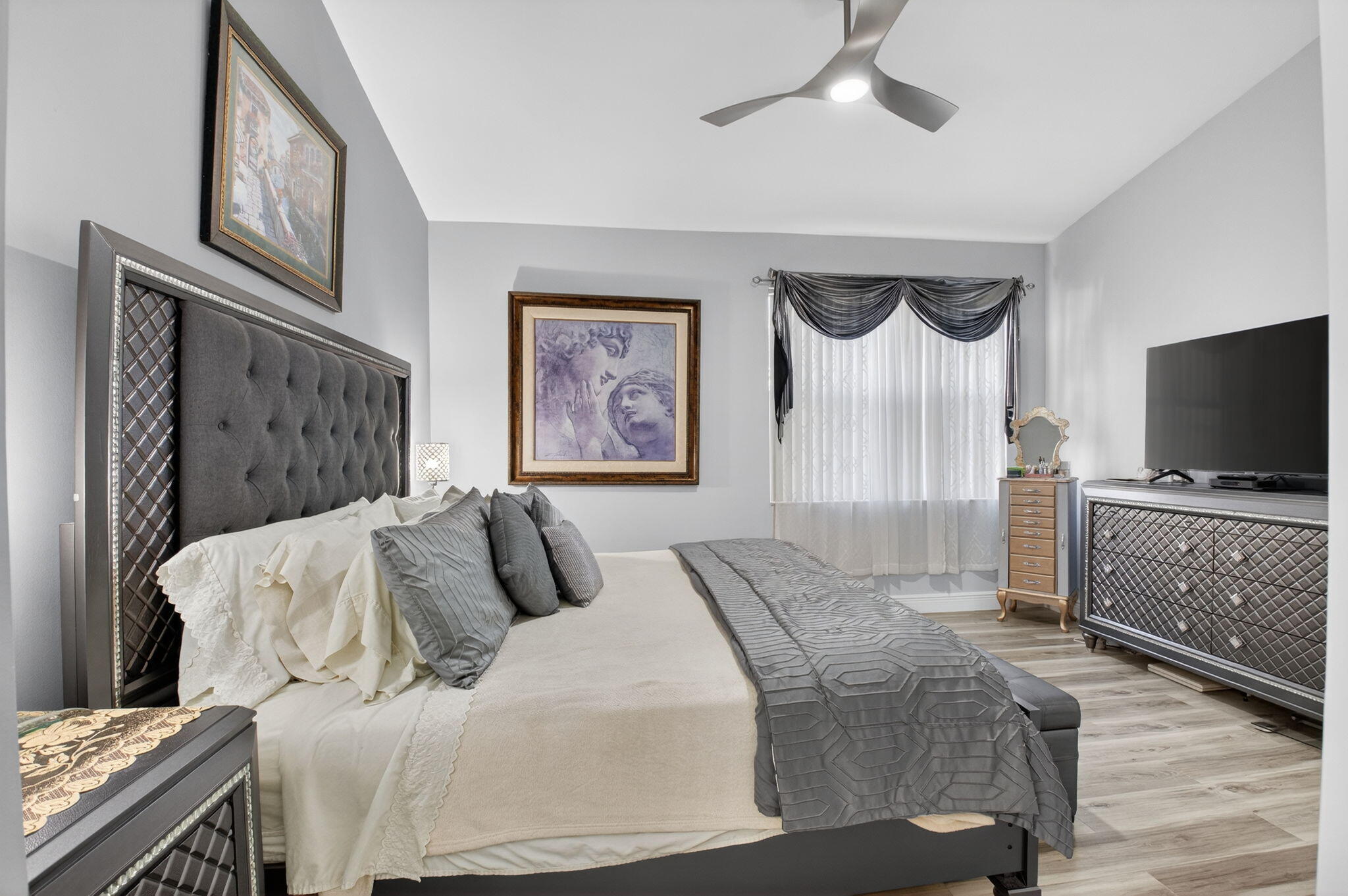 6247 Heliconia Road Delray Beach, FL 33484 - Photo 12 of 25 a bedroom with a bed and a flat screen tv