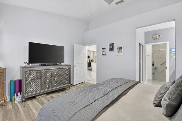 a bedroom with bed and flat screen tv