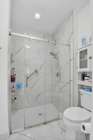 a bathroom with a toilet and shower