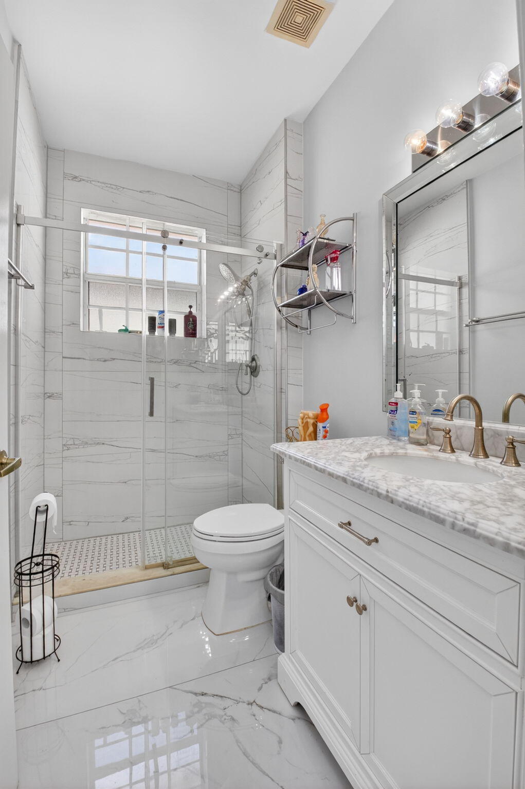 6247 Heliconia Road Delray Beach, FL 33484 - Photo 19 of 25 a bathroom with a granite countertop sink a toilet and a shower