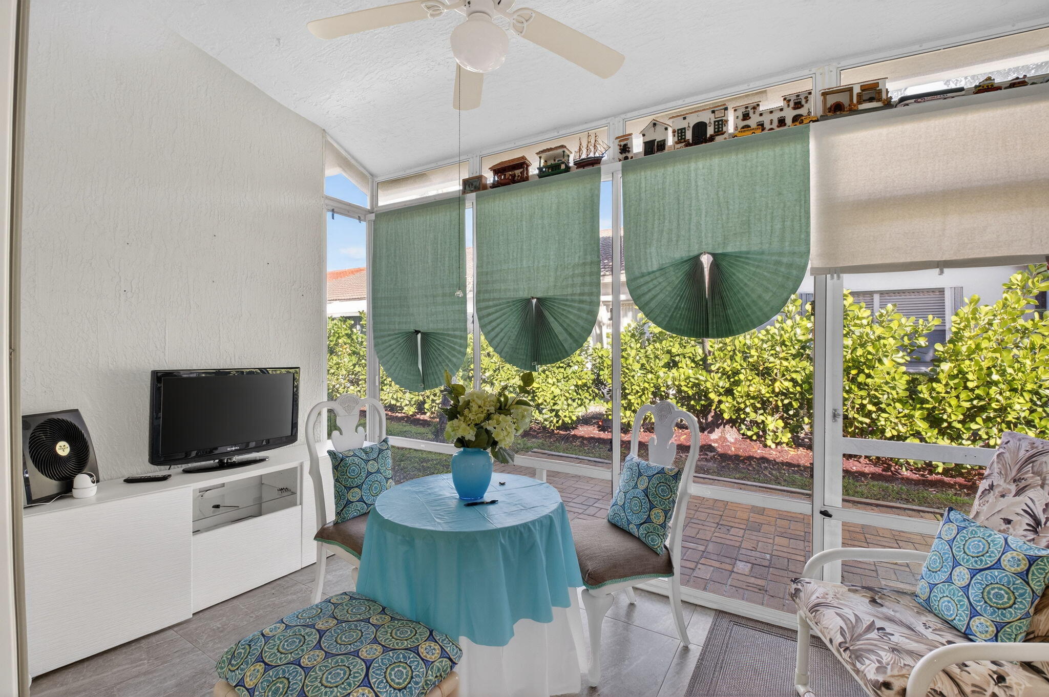 6247 Heliconia Road Delray Beach, FL 33484 - Photo 20 of 25 a living room with furniture and a flat screen tv