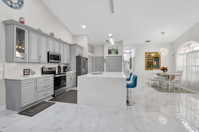 a large white kitchen with cabinets