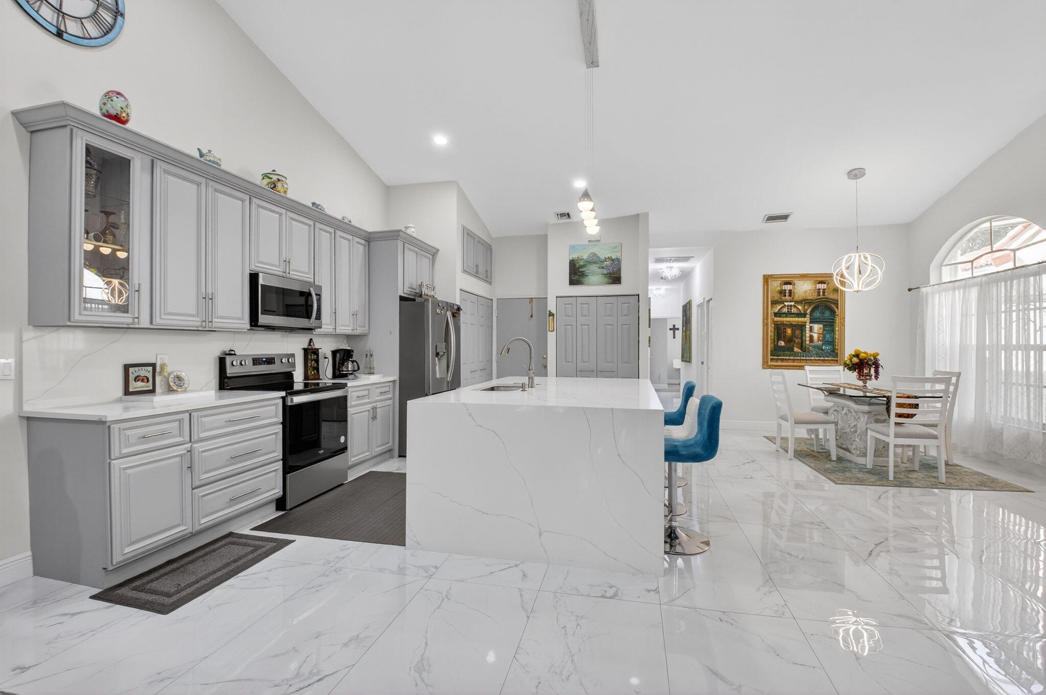 6247 Heliconia Road Delray Beach, FL 33484 - Photo 3 of 25 a large white kitchen with cabinets