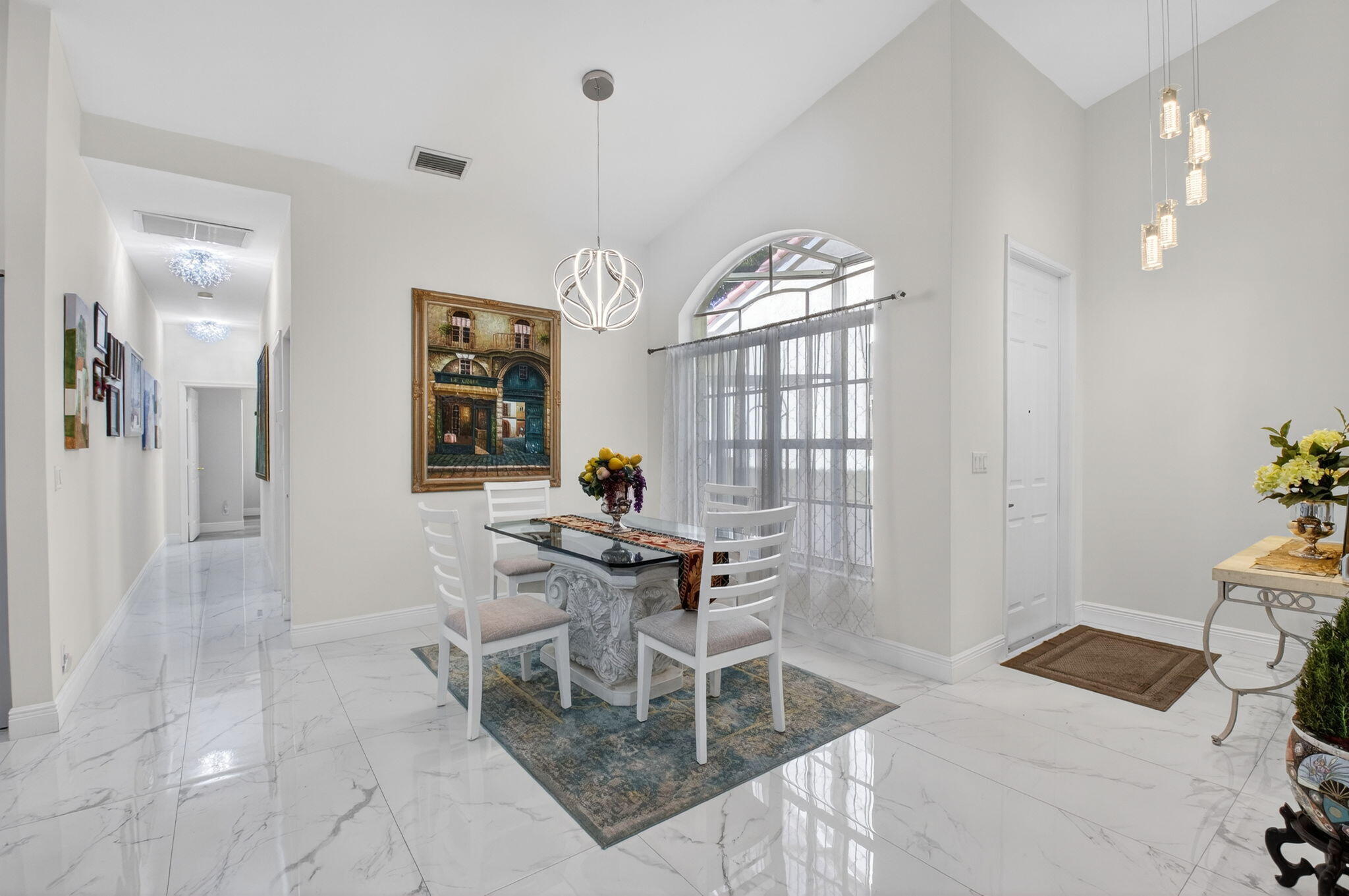 6247 Heliconia Road Delray Beach, FL 33484 - Photo 4 of 25 a living room with furniture and a chandelier