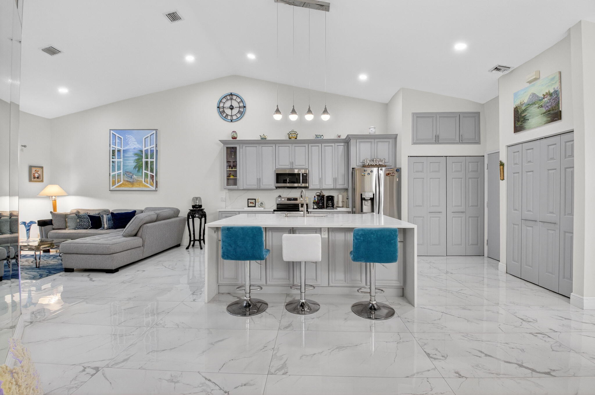 6247 Heliconia Road Delray Beach, FL 33484 - Photo 10 of 25 a living room with furniture and a chandelier