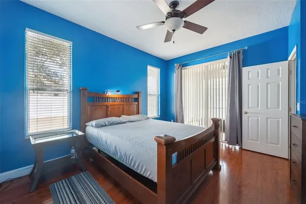 a bedroom with a large bed a chandelier and a window
