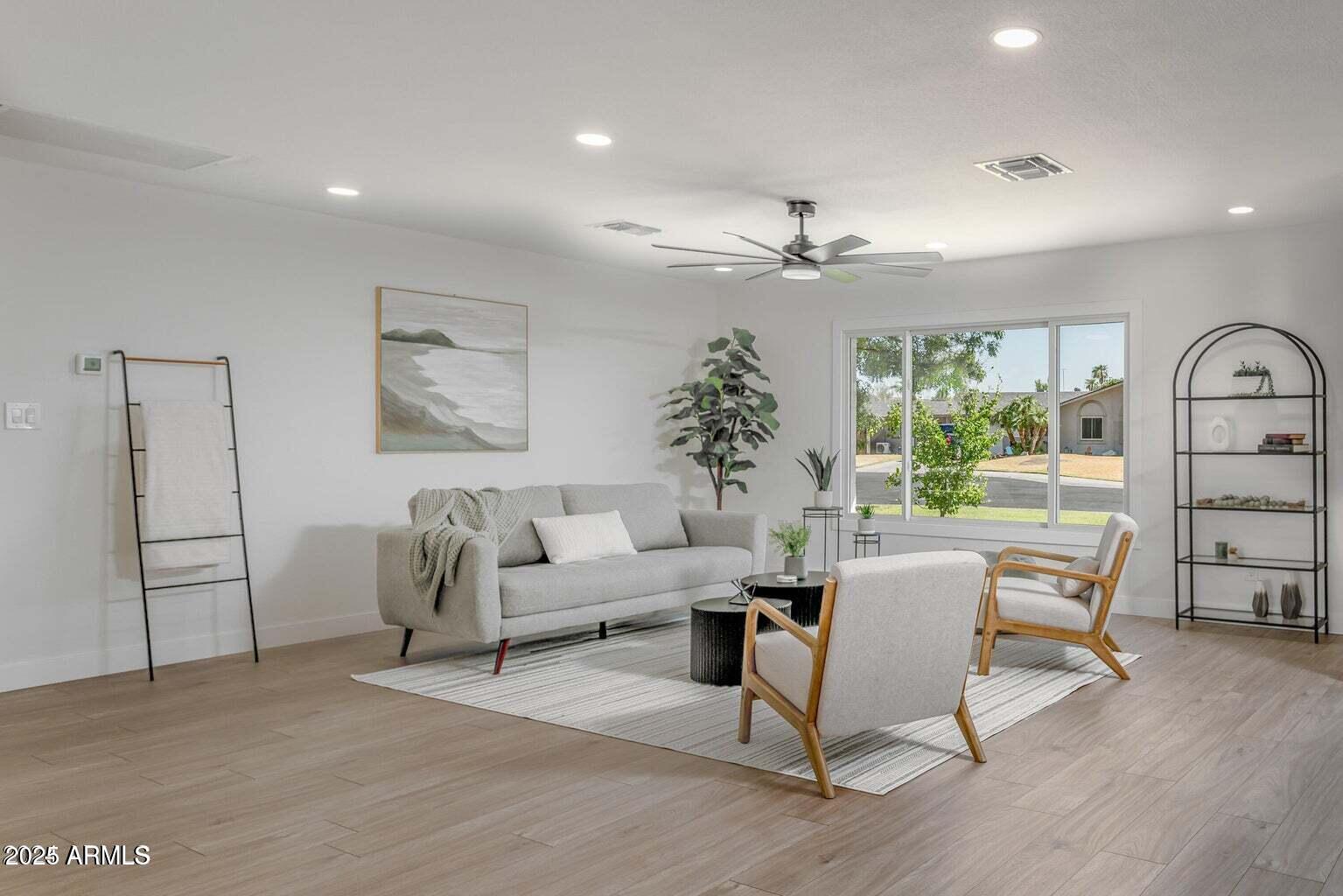4414 South Terrace Road Tempe, AZ 85282 - Photo 13 of 24 a living room with furniture a large window and wooden floor