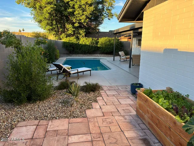 a backyard of a house with table and chairs
