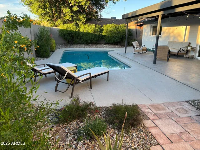 a backyard of a house with table and chairs