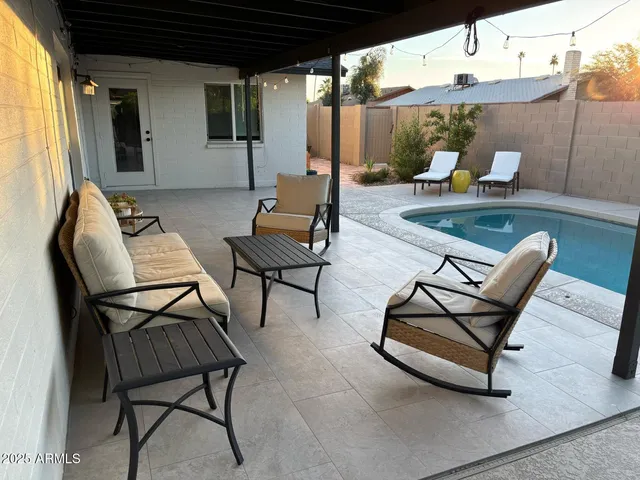 a patio with patio couch and chairs