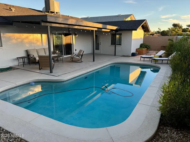 a view of a swimming pool with sitting area