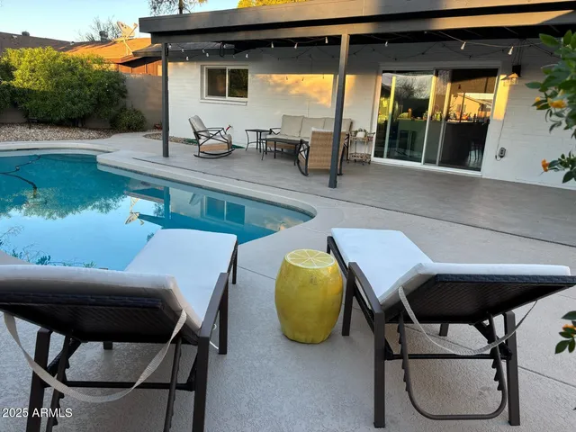 a view of a patio with table and chairs a barbeque