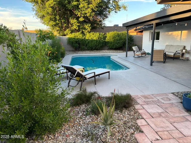 a view of a backyard with sitting area