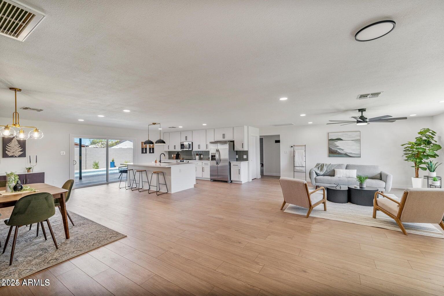 4414 South Terrace Road Tempe, AZ 85282 - Photo 10 of 24 a living room with furniture and a dining table with kitchen view