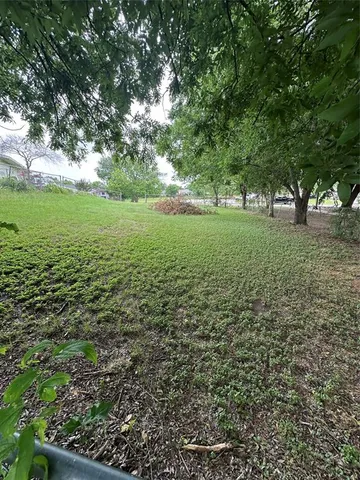 a view of outdoor space with trees all around