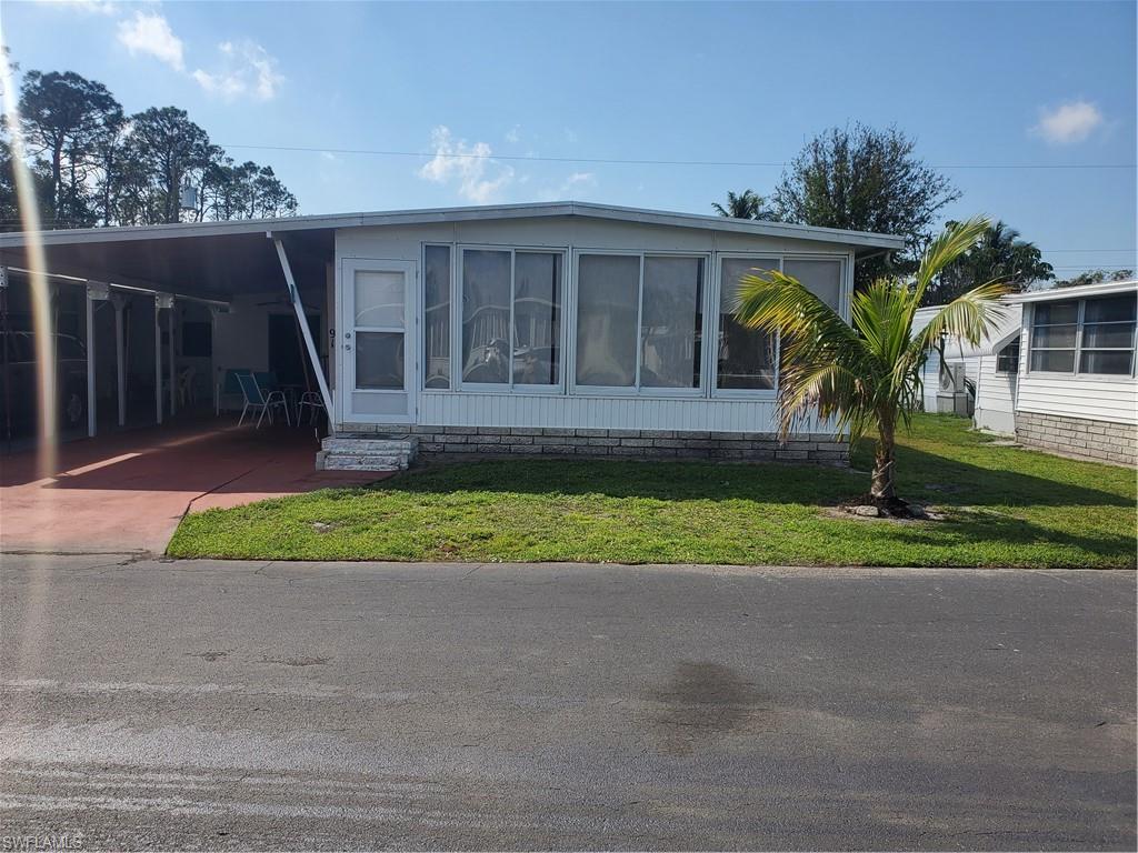 91 Enchanting Boulevard, Unit E91 Naples, FL 34112 - Photo 1 of 23 a front view of house with yard and green space