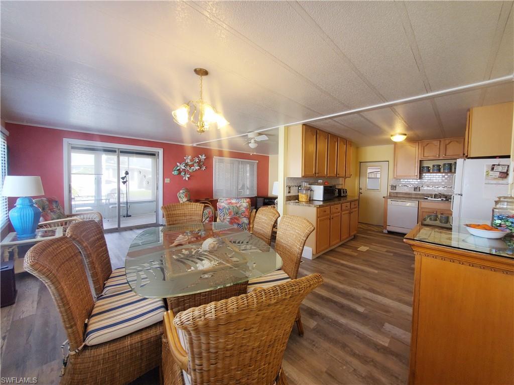 91 Enchanting Boulevard, Unit E91 Naples, FL 34112 - Photo 11 of 23 a living room with stainless steel appliances kitchen island granite countertop furniture and a kitchen view
