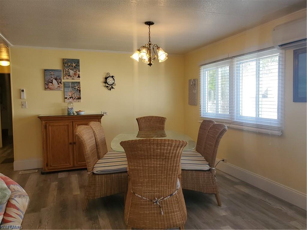 91 Enchanting Boulevard, Unit E91 Naples, FL 34112 - Photo 12 of 23 a dining room with furniture and window
