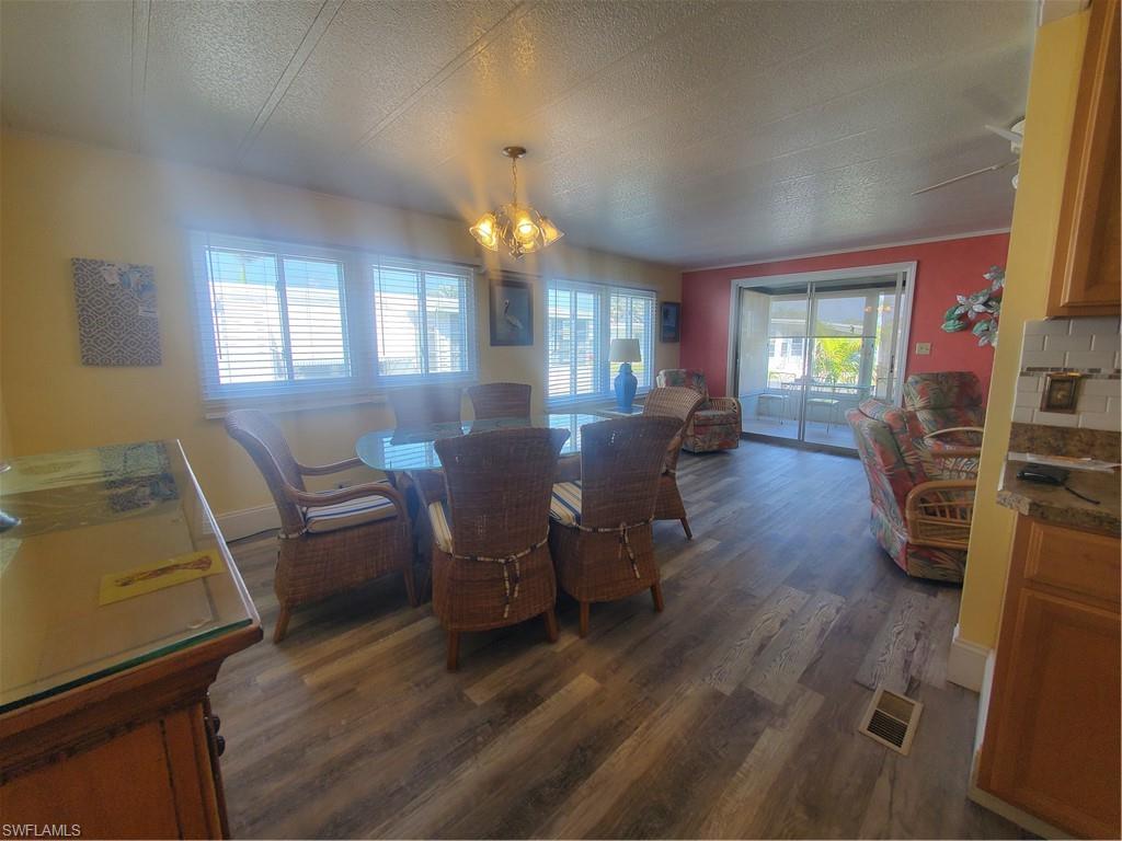 91 Enchanting Boulevard, Unit E91 Naples, FL 34112 - Photo 14 of 23 a view of a dining room with furniture window and wooden floor