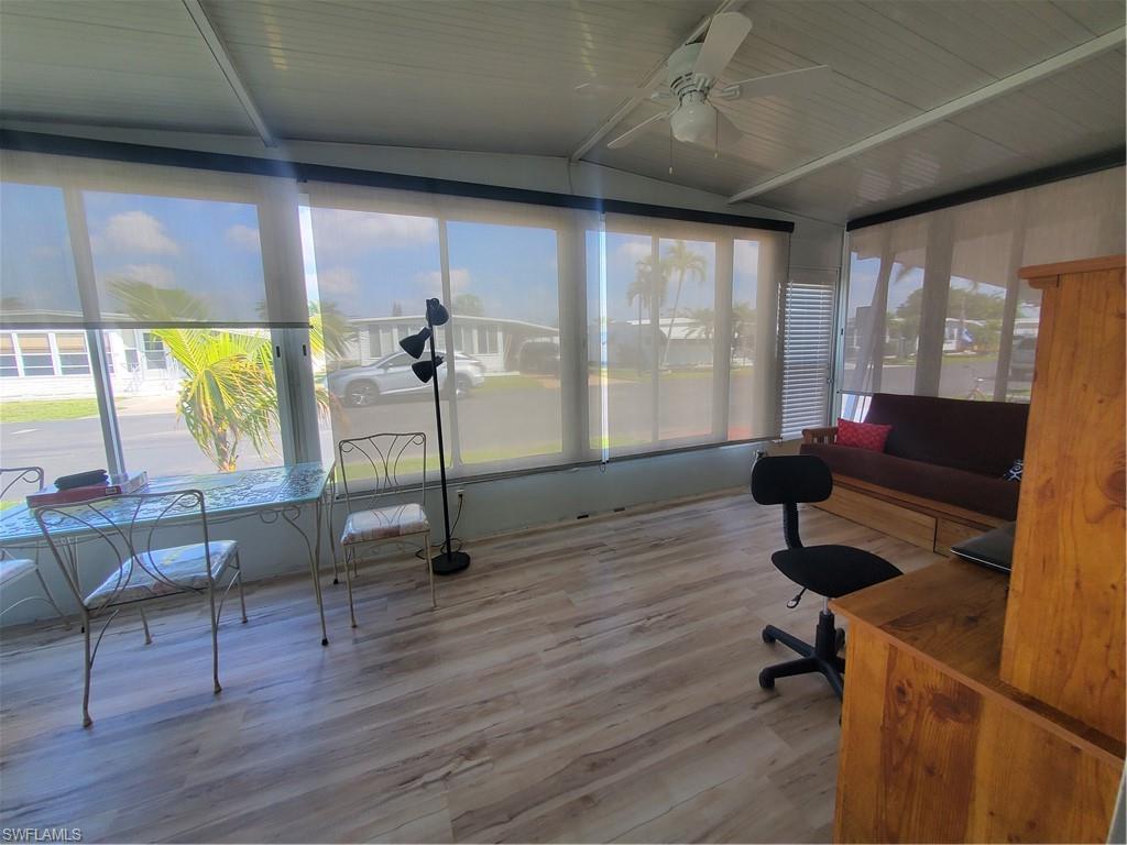91 Enchanting Boulevard, Unit E91 Naples, FL 34112 - Photo 15 of 23 a living room with furniture and a wooden floor