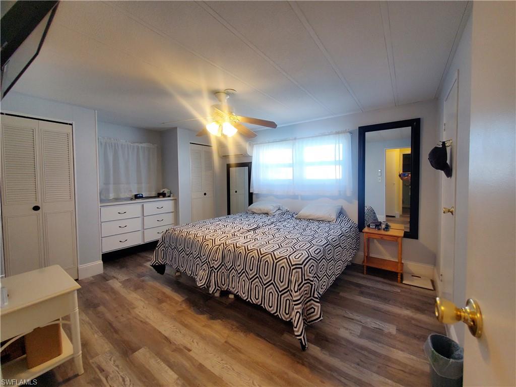 91 Enchanting Boulevard, Unit E91 Naples, FL 34112 - Photo 18 of 23 a bedroom with a bed and a dresser