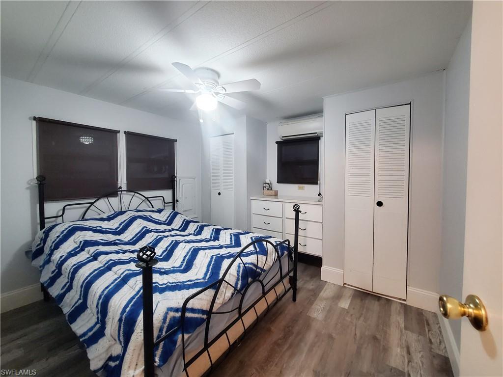 91 Enchanting Boulevard, Unit E91 Naples, FL 34112 - Photo 20 of 23 a bedroom with a bed and a flat screen tv