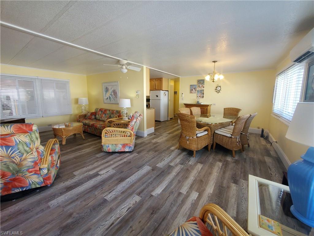 91 Enchanting Boulevard, Unit E91 Naples, FL 34112 - Photo 3 of 23 a living room with furniture and wooden floor