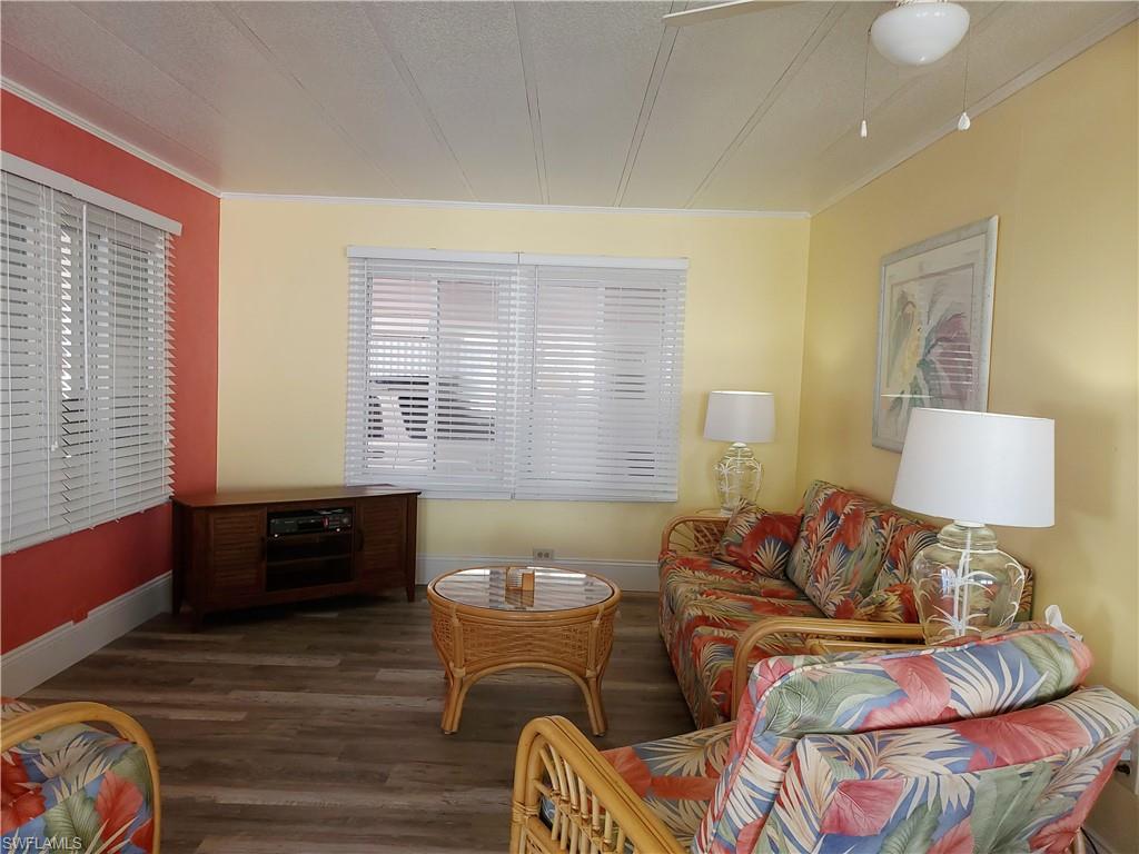 91 Enchanting Boulevard, Unit E91 Naples, FL 34112 - Photo 6 of 23 a living room with furniture and a window