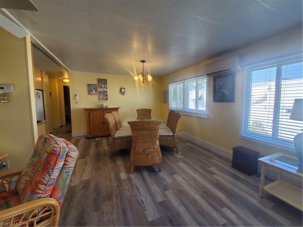 91 Enchanting Boulevard, Unit E91 Naples, FL 34112 - Photo 9 of 23 a living room with furniture and wooden floor
