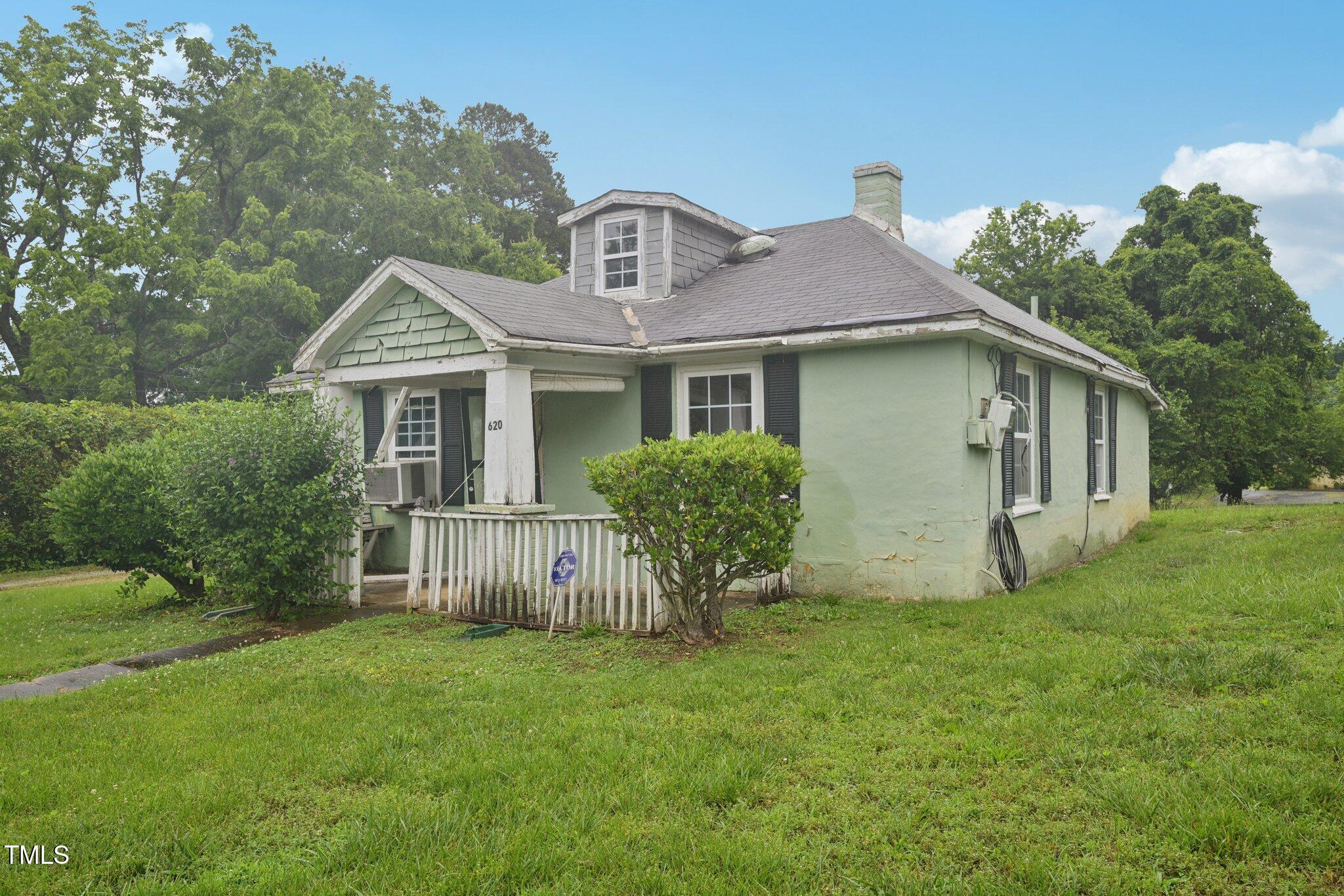 620 McAdams Road Hillsborough, NC 27278 - Photo 3 of 24 a view of a house with a yard and a garden