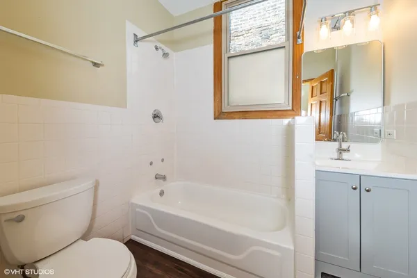 a bathroom with a toilet a sink and bathtub