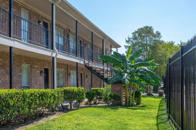 a view of a brick building with a potted plant